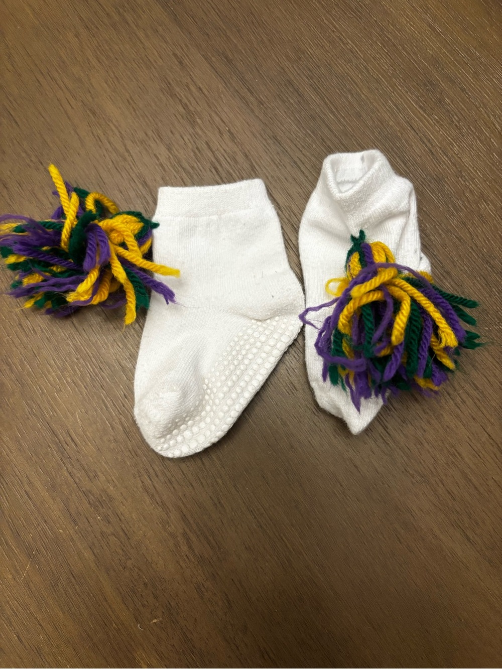 Mardi Gras White Baby Socks with Purple, Green & Yellow Pom Poms